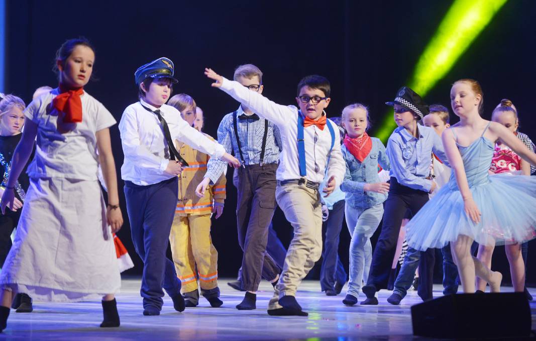 Group of young students on stage dancing at festival