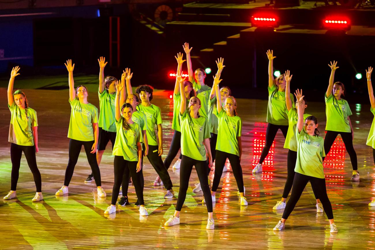 student dancers in green tshirts