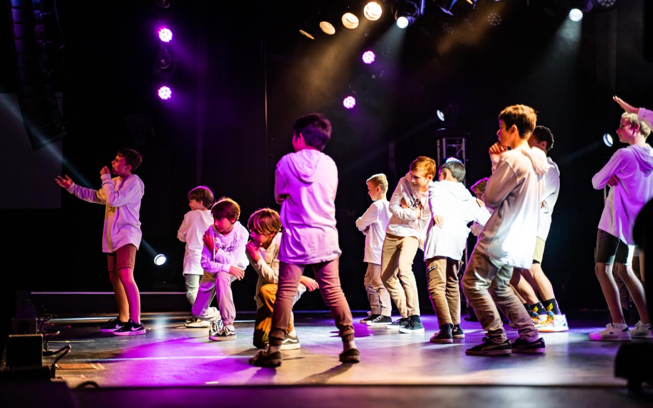 Primary school students dancing on stage