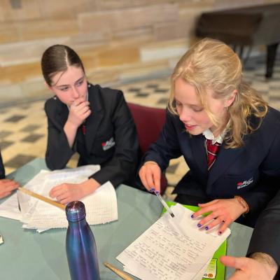 Student team planning their notes for the debate